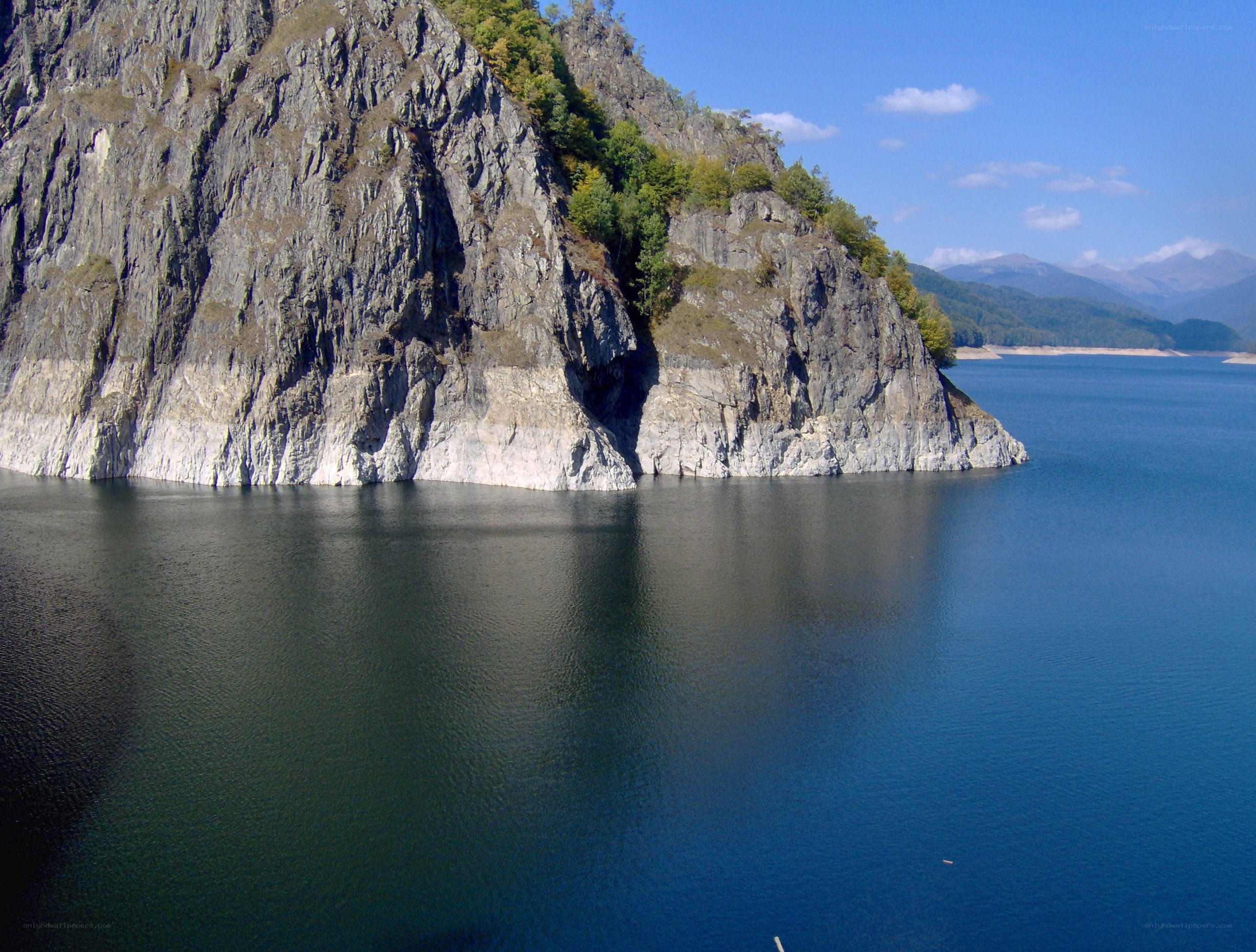 Cliffside lake with mountains