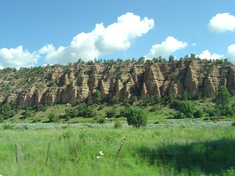 cliffside landscape with green field