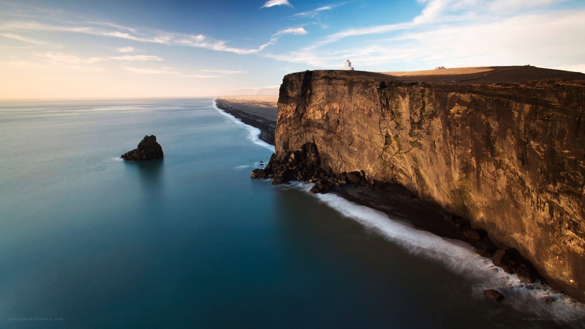 Cliffside lighthouse at sunset