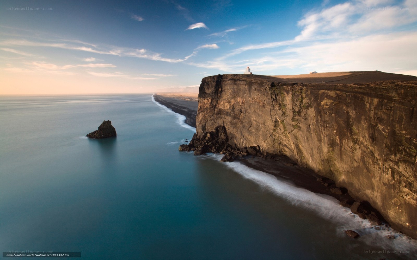 Cliffside lighthouse at sunset