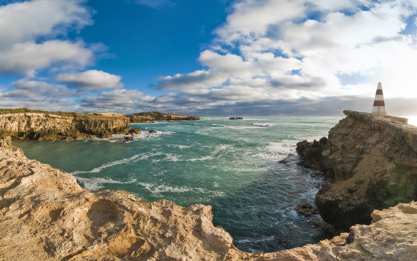Cliffside lighthouse by the sea