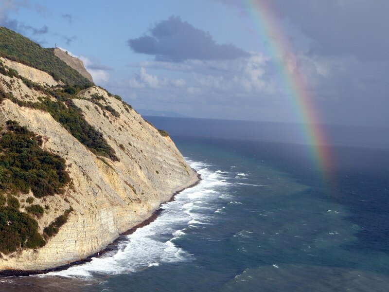 Cliffside Rainbow over Ocean — Blue, Serene, Afternoon, Photograph