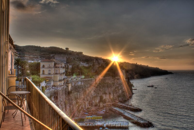 Cliffside Town at Sunset — Orange, Dramatic, Photograph