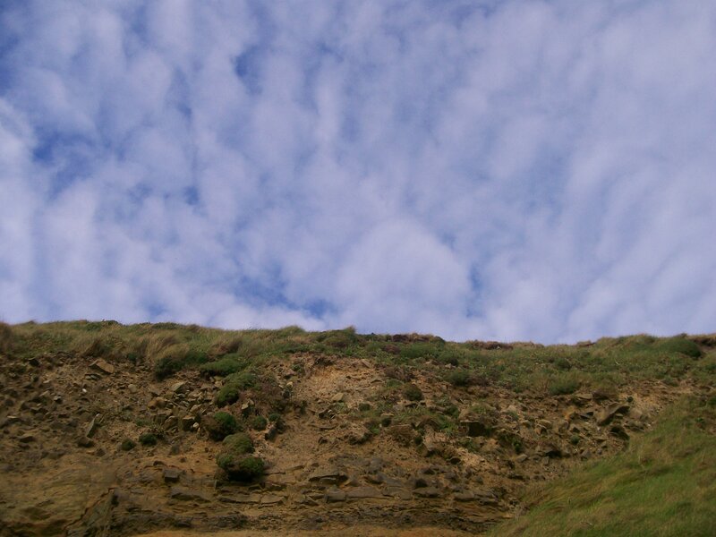 Cliffside under cloudy sky