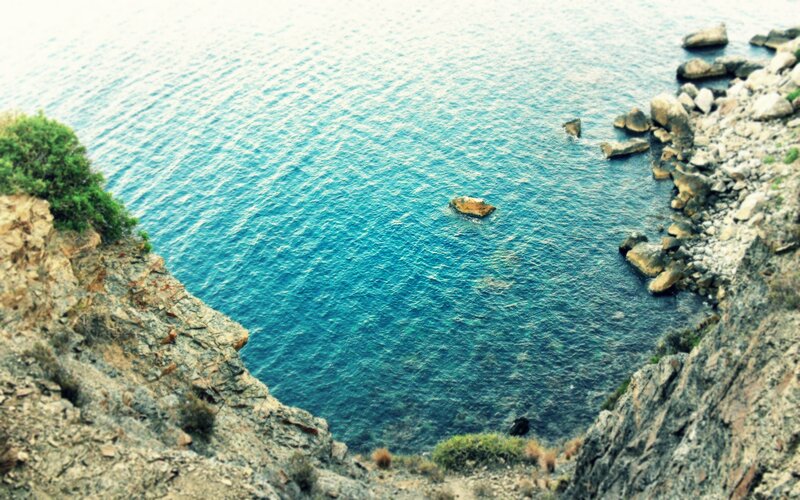 cliffside view of blue sea