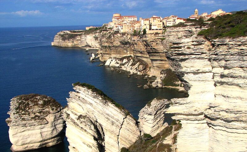 Cliffside Village by Sea — Blue, Serene, Afternoon, Photograph, Cliffs