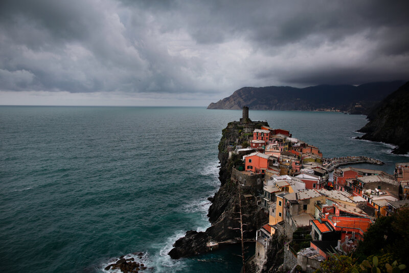 Cliffside village under stormy sky