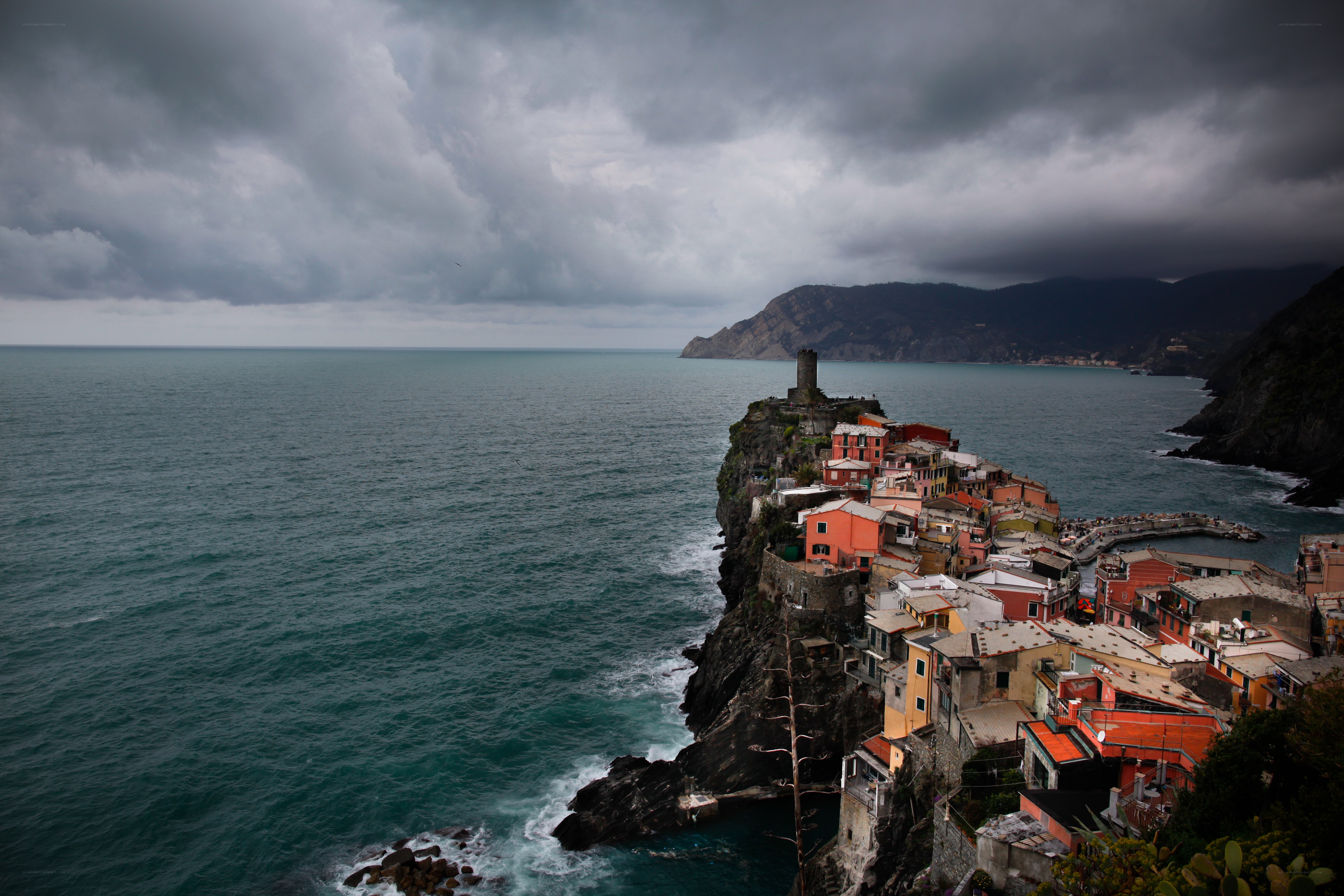 Cliffside village under stormy sky