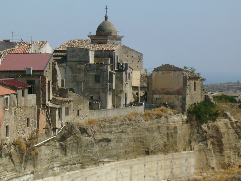cliffside village with church dome