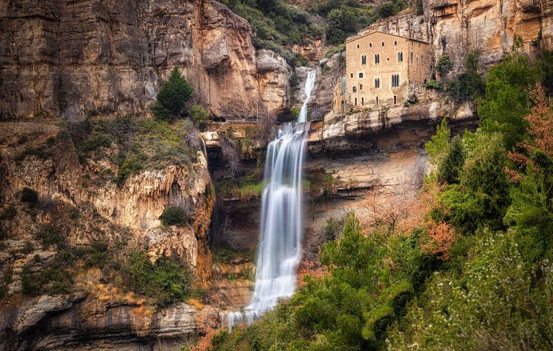 Cliffside Waterfall and Building