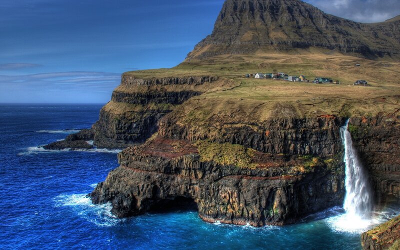 cliffside waterfall in faroe islands