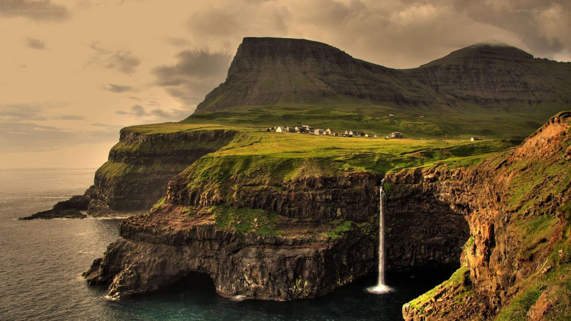 cliffside waterfall in faroe islands