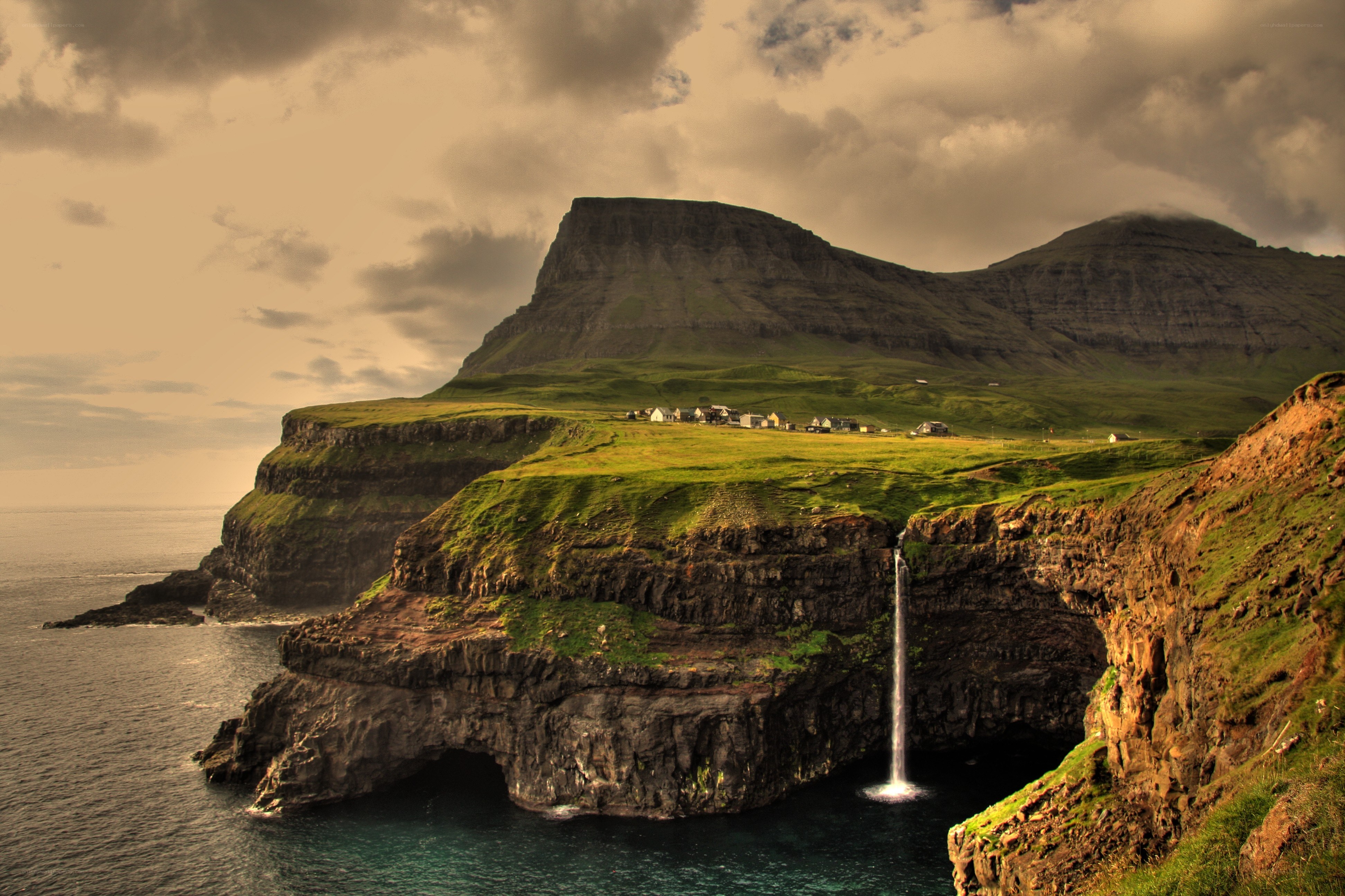 cliffside waterfall in faroe islands