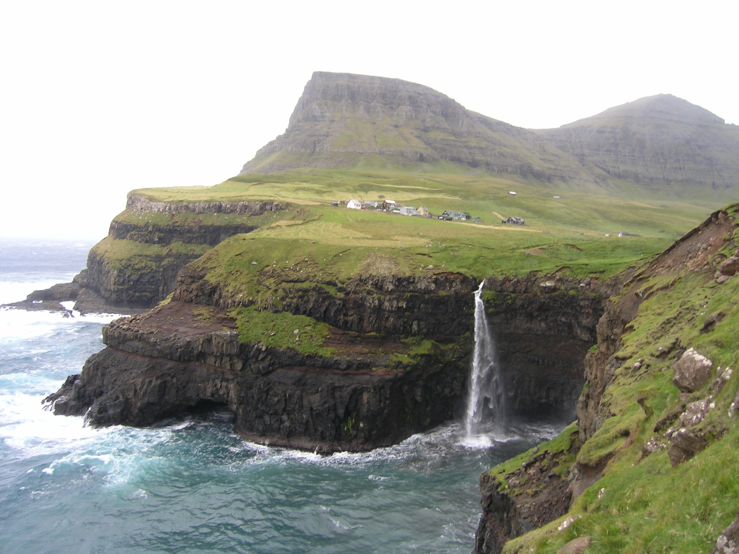 cliffside waterfall in faroe islands