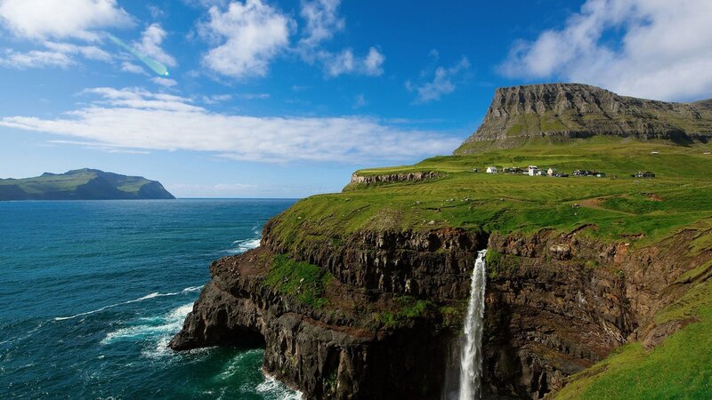 cliffside waterfall in faroe islands