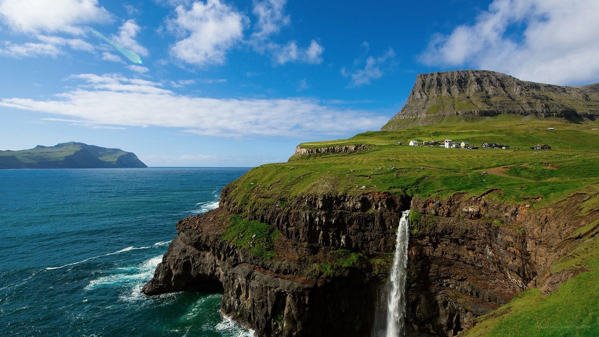 cliffside waterfall in faroe islands