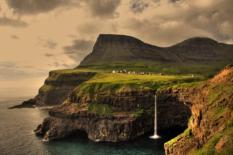Cliffside Waterfall Village — Green, Dramatic, Afternoon