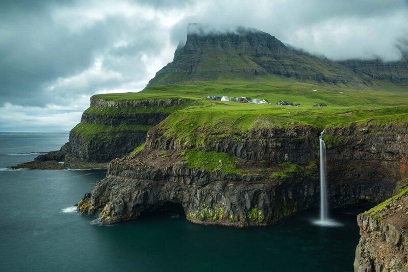 Cliffside Waterfall Village — Green, Dramatic, Photograph