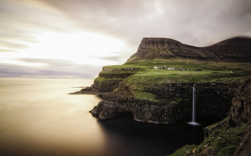 Cliffside Waterfall Village — Green, Dramatic, Sunset