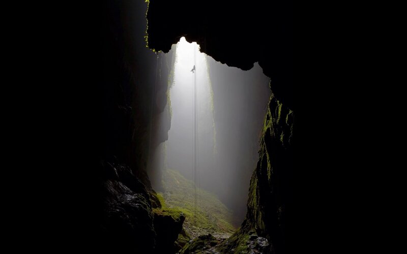 Climber in a deep cave