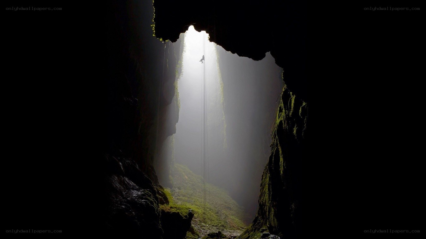 Climber in a deep cave