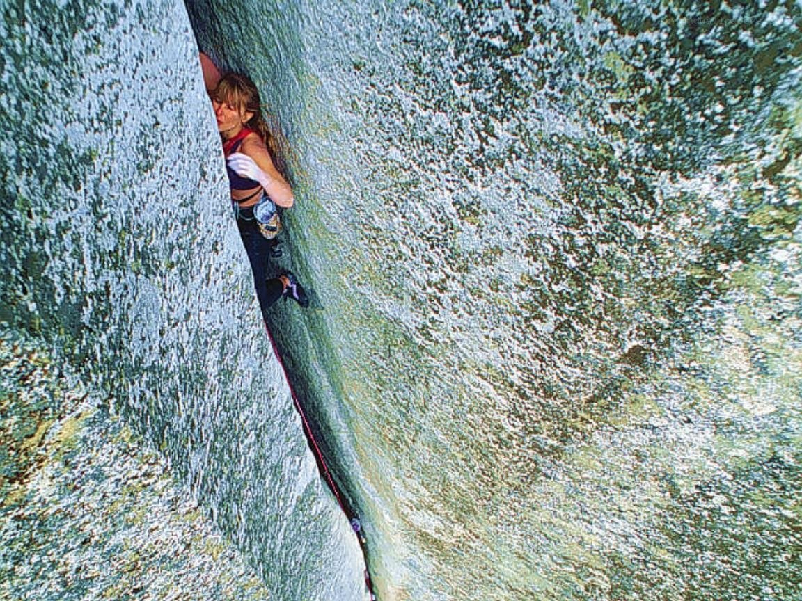 Climber in a narrow rock crack