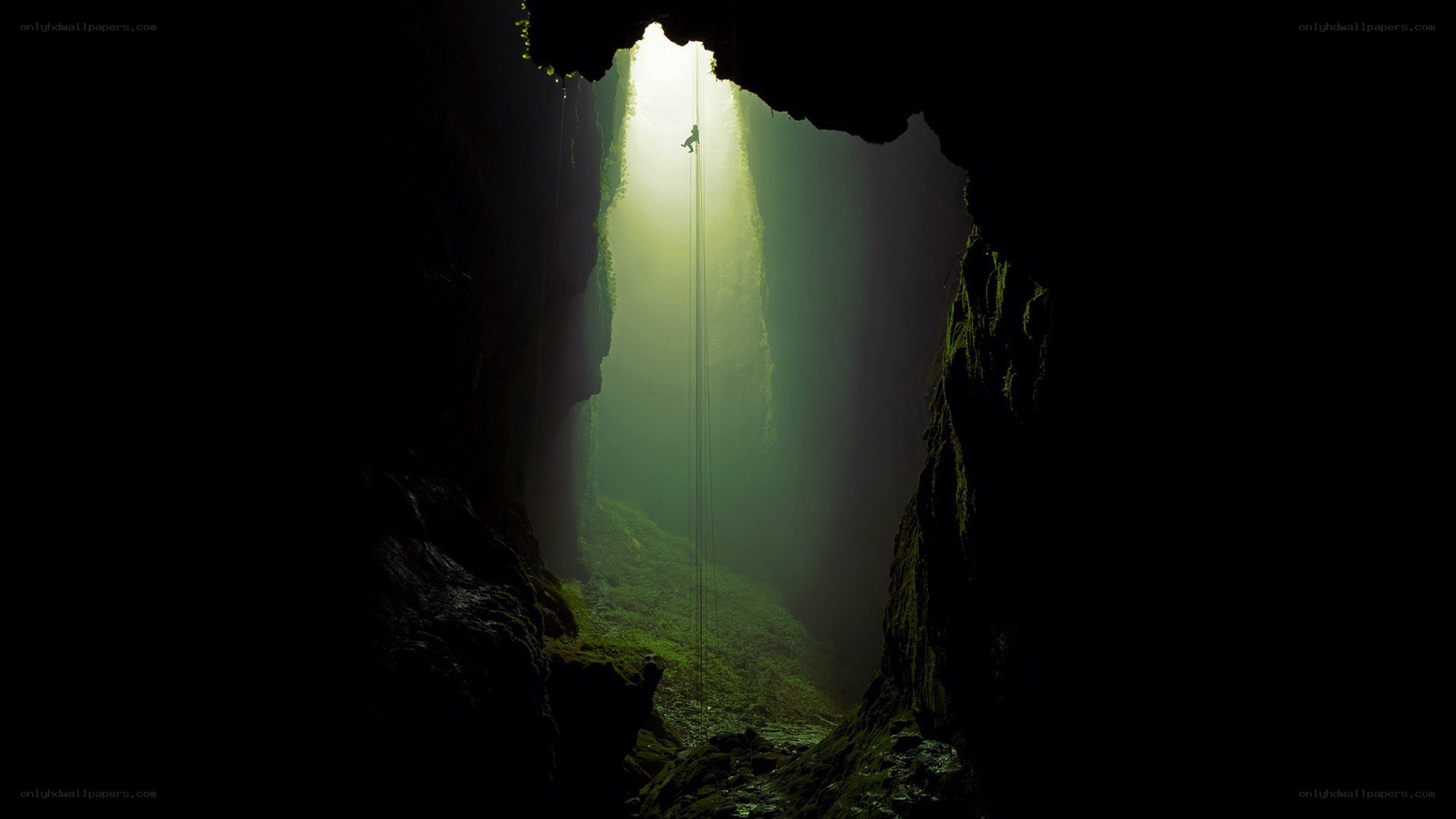 Climber in a sunlit cave