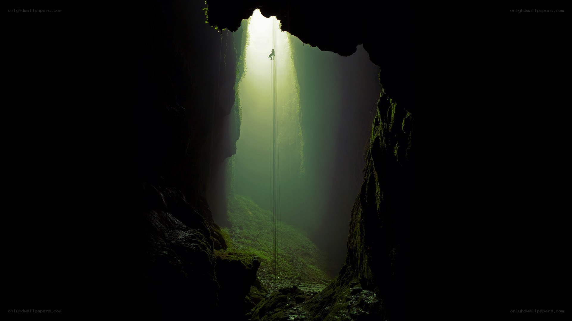 Climber in a sunlit cave