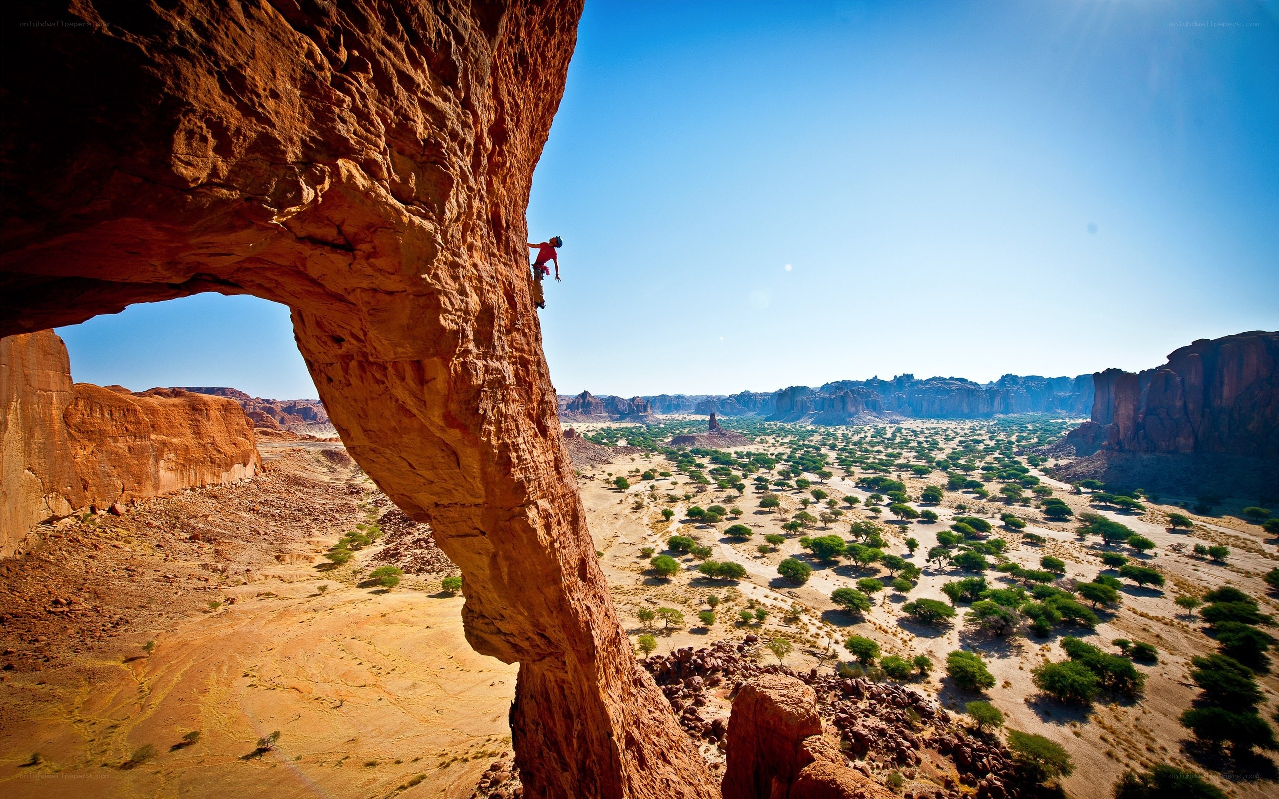 Climber on a desert rock arch