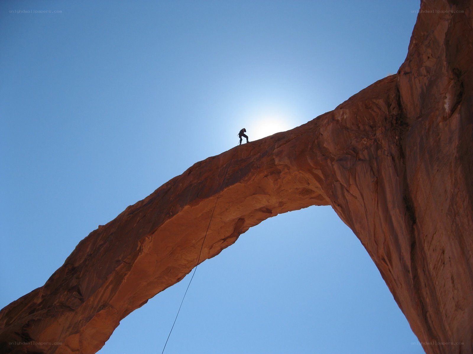Climber on a natural arch