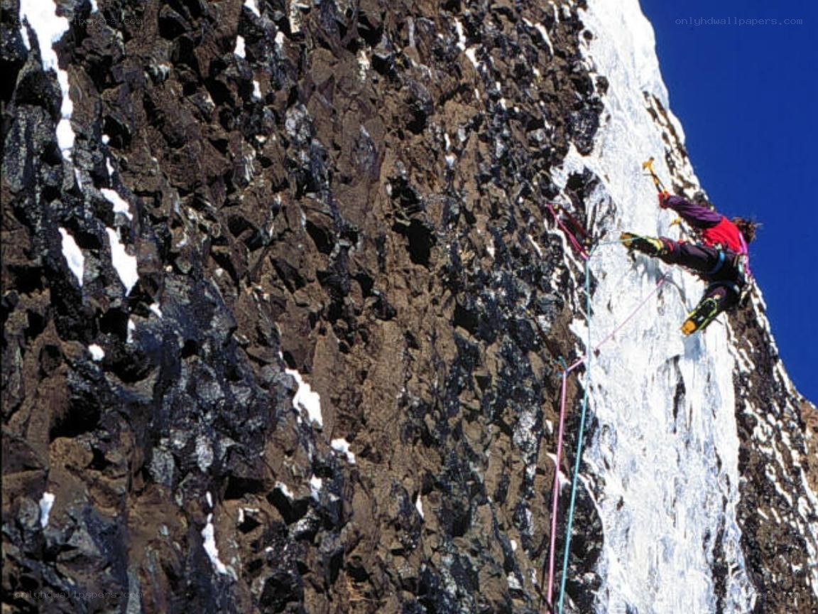 Climber on a snowy cliff