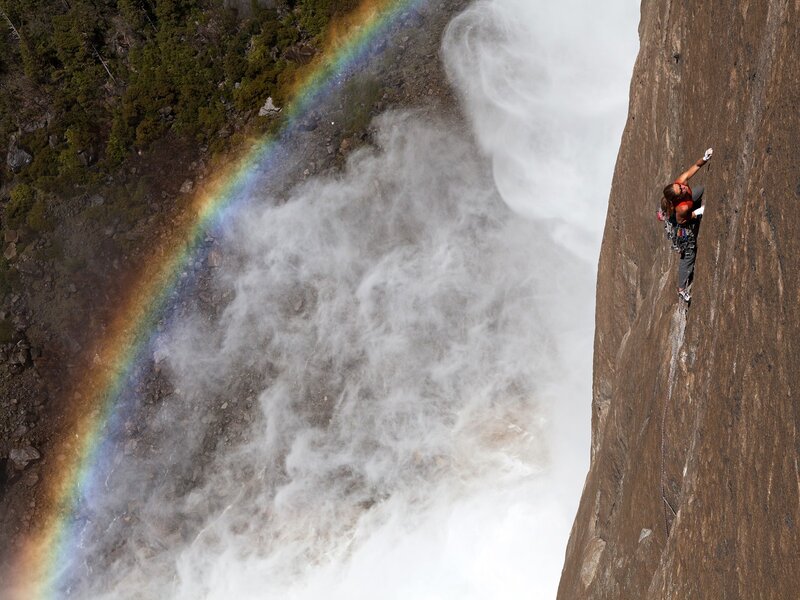 Climber on a waterfall cliff
