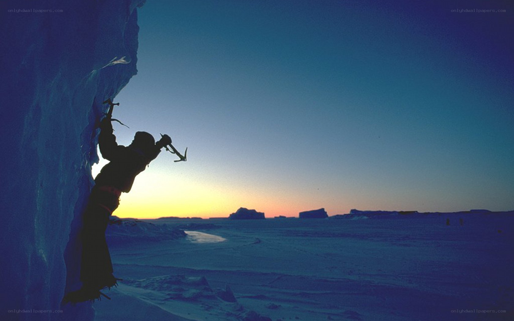 Climber on an ice wall at sunset