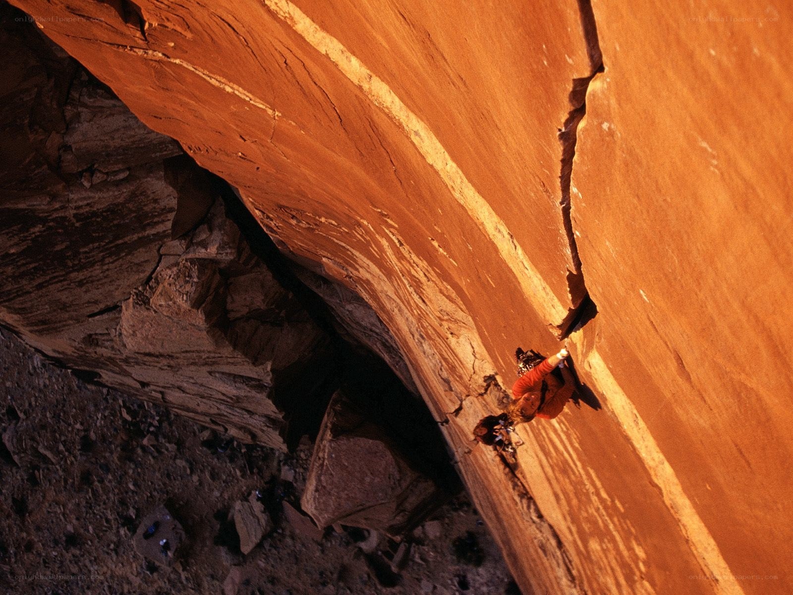 Climber on red rock face