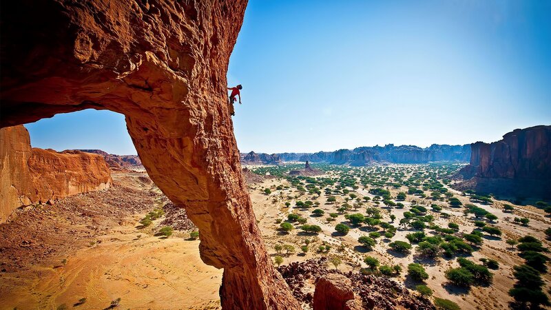 Climber on Rock Arch — Red, Dramatic