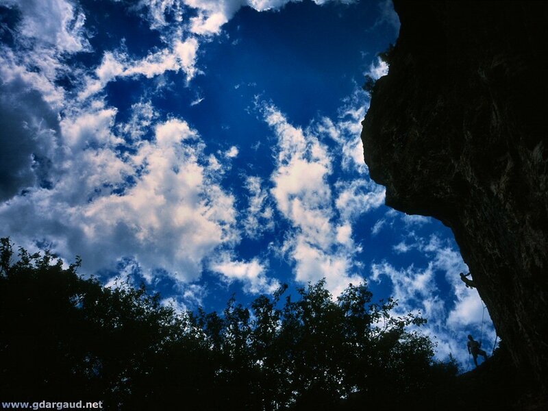 Climber on Rock Face — Blue