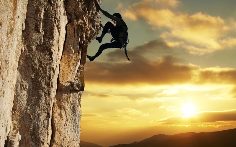 Climber on Rock Face — Dramatic