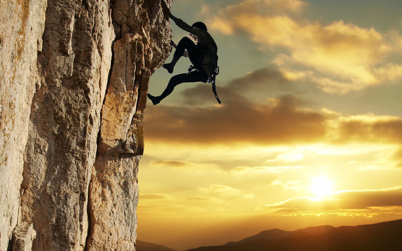 Climber on Rock Face — Sky