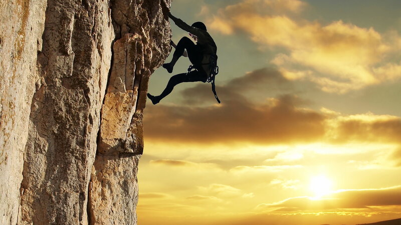 Climber on Rock Face — Sun