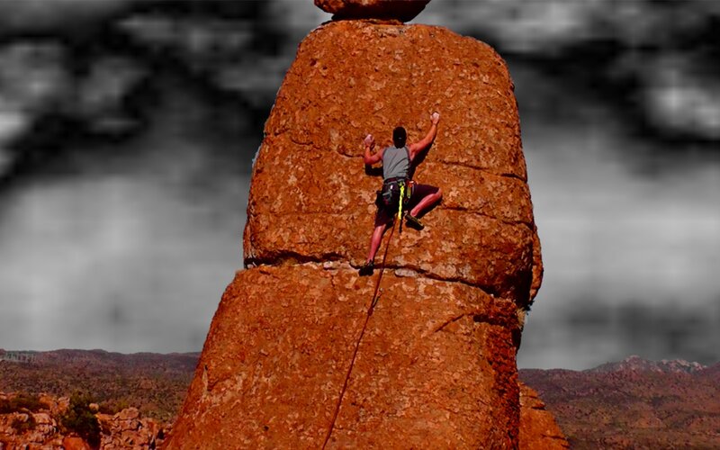 Climber on Rock Formation — Brown