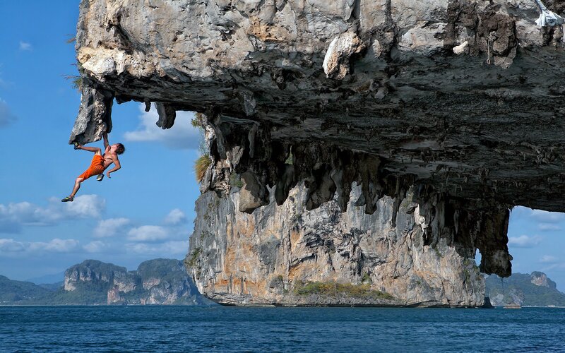 Climber on Rock Overhang — Blue