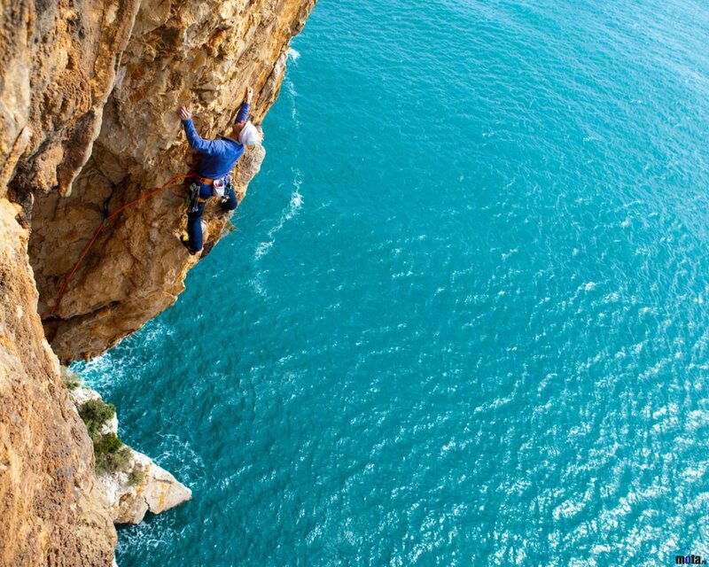 Climber on Sea Cliff — Blue