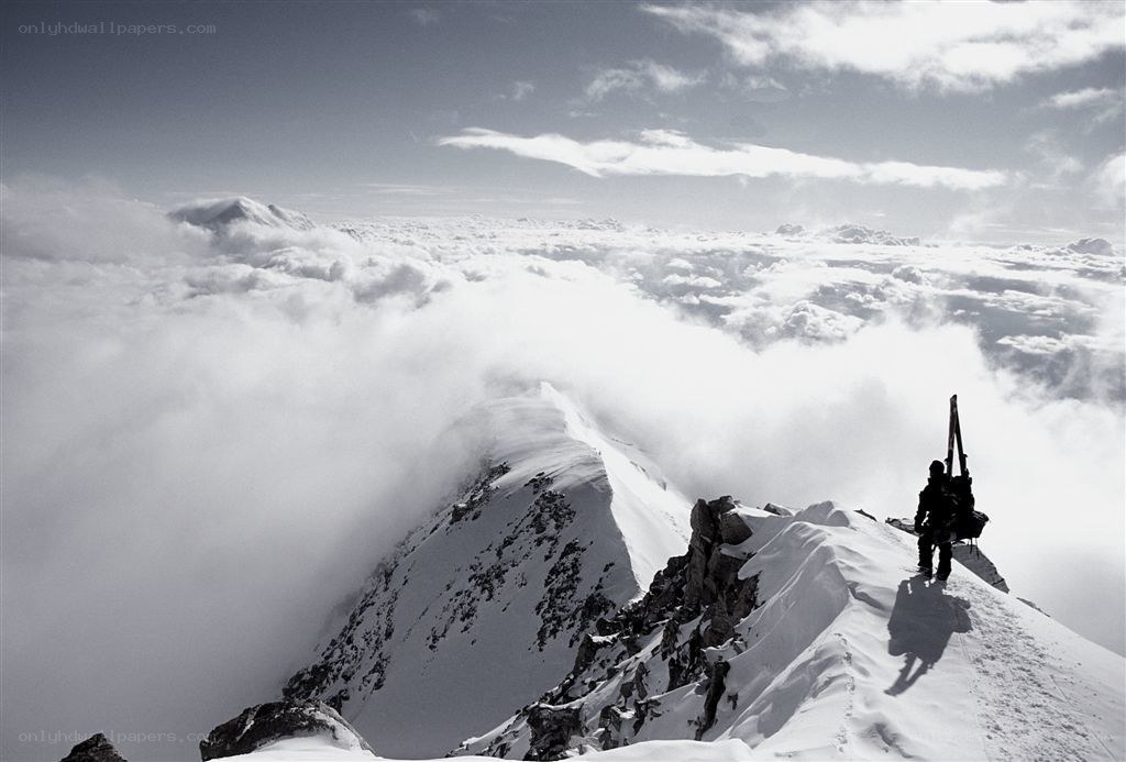Climber on snowy mountain peak
