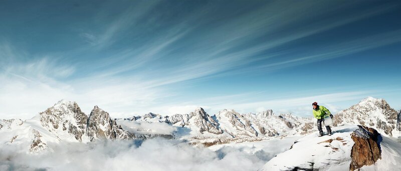 Climber on snowy mountain peak
