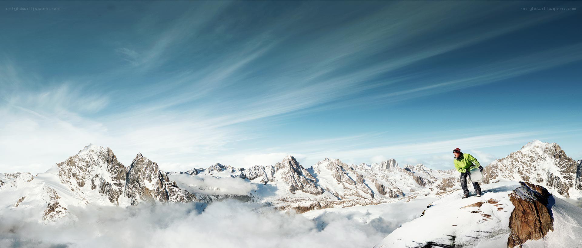 Climber on snowy mountain peak