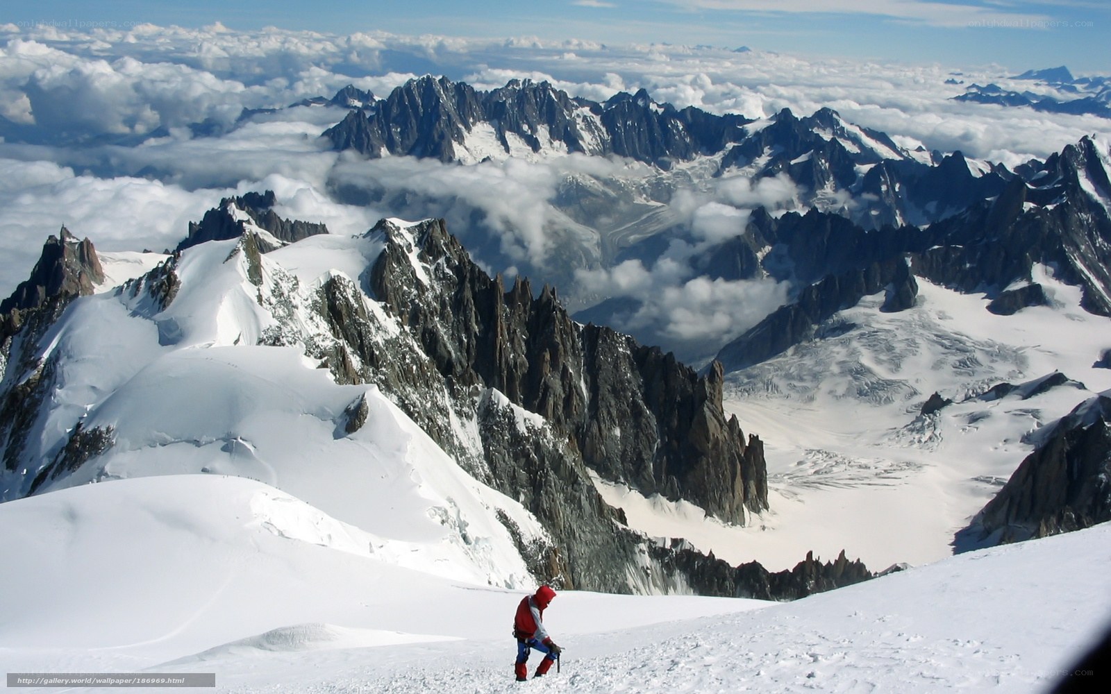 Climber on snowy mountain peak