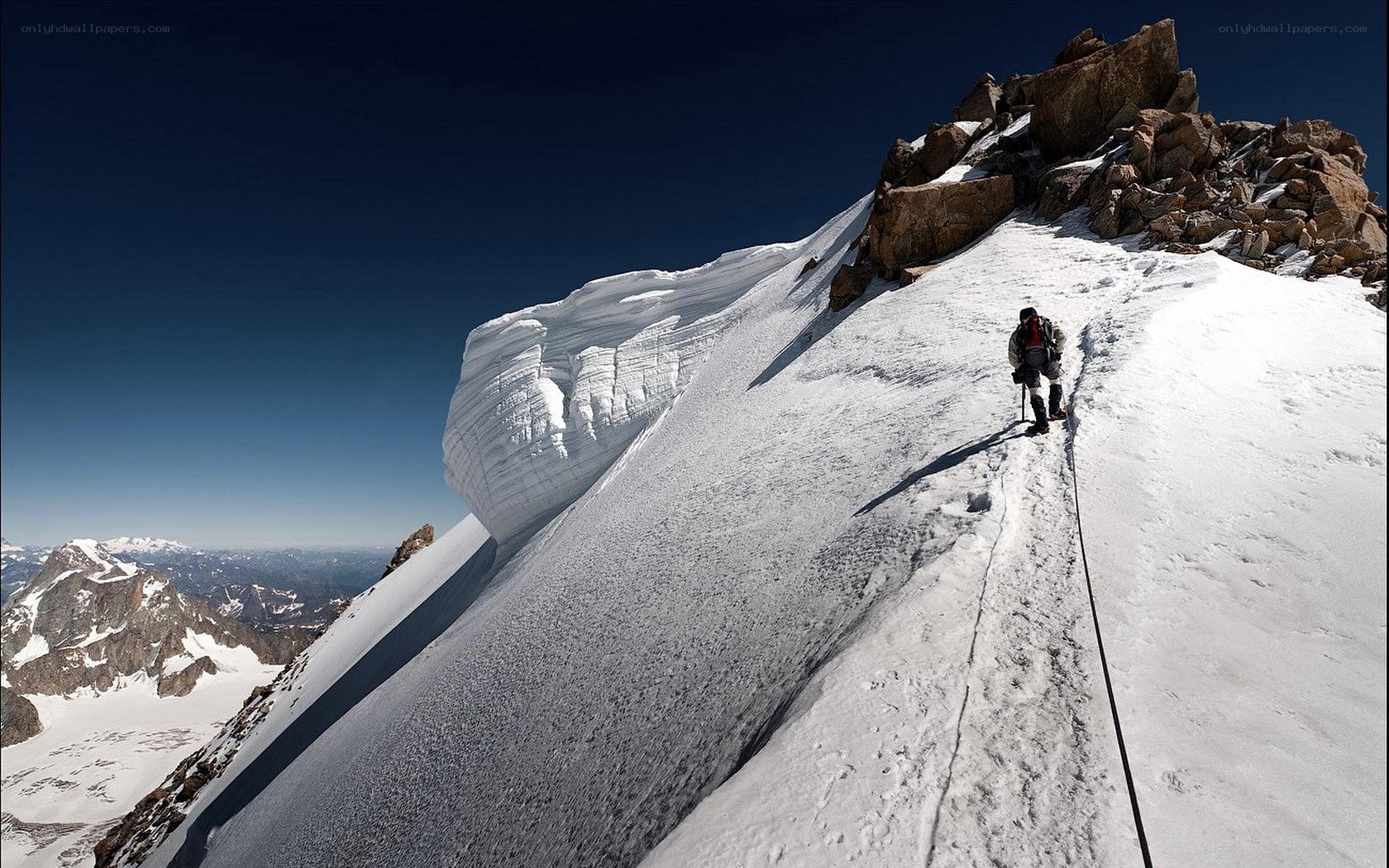 Climber on snowy mountain slope