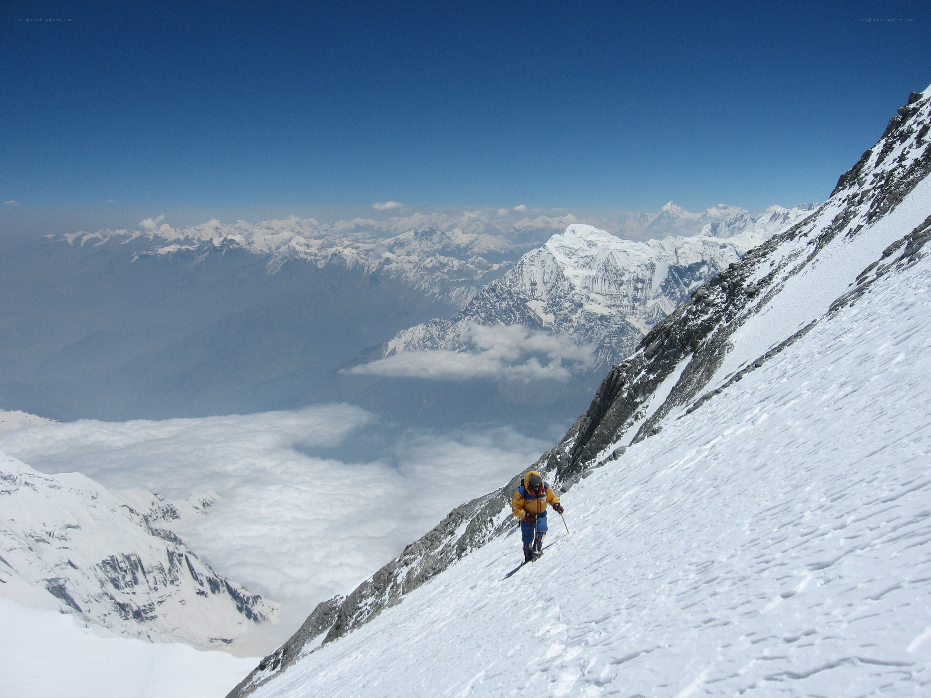 Climber on snowy mountain slope