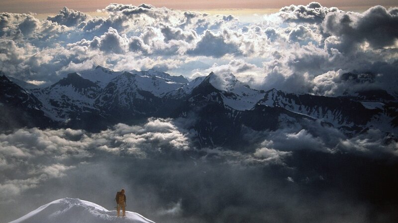 Climber on Snowy Peak