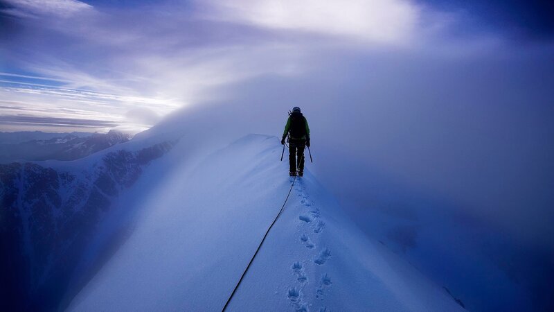 Climber on Snowy Ridge